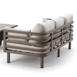Outdoor sofa with taupe metal frame and beige cushions, angled rear view