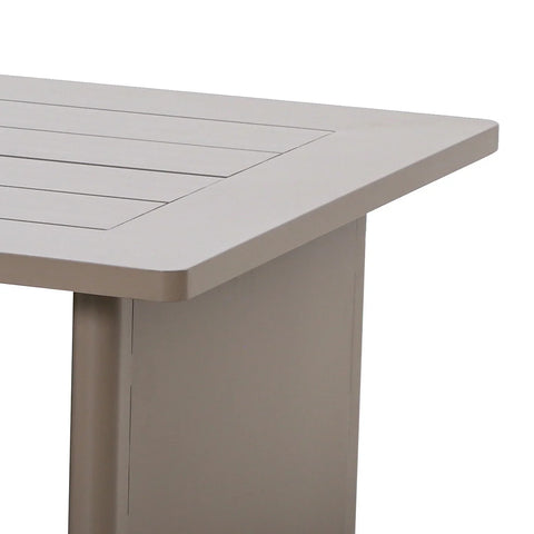 Beige slatted dining table corner with sturdy leg and smooth finish