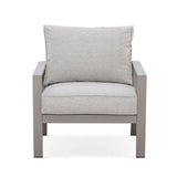 Grey fabric armchair with metal frame and plush cushions, front view