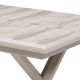 Light wood effect dining table with angled metal legs, close-up of tabletop corner