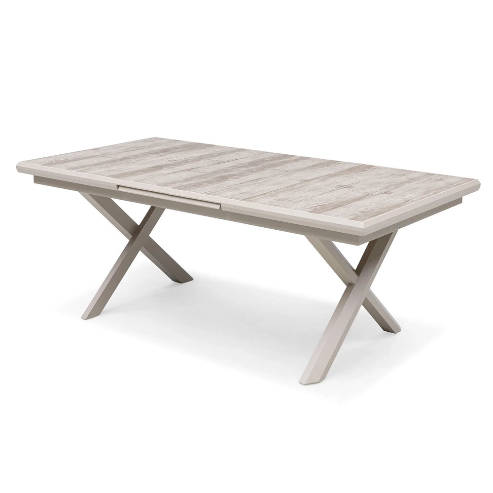 Rectangular dining table with light wood top and modern crossed legs