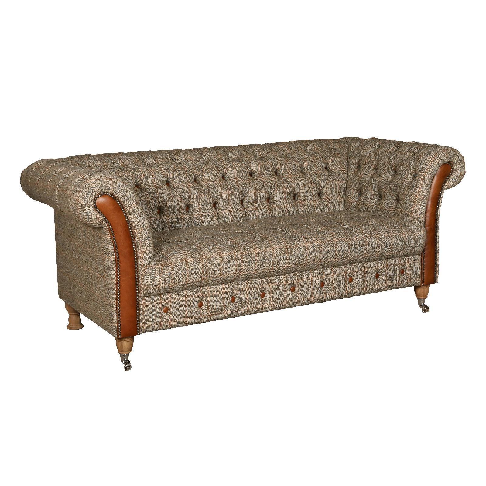 Chesterfield style fabric sofa with button tufting and brown leather rolled arms