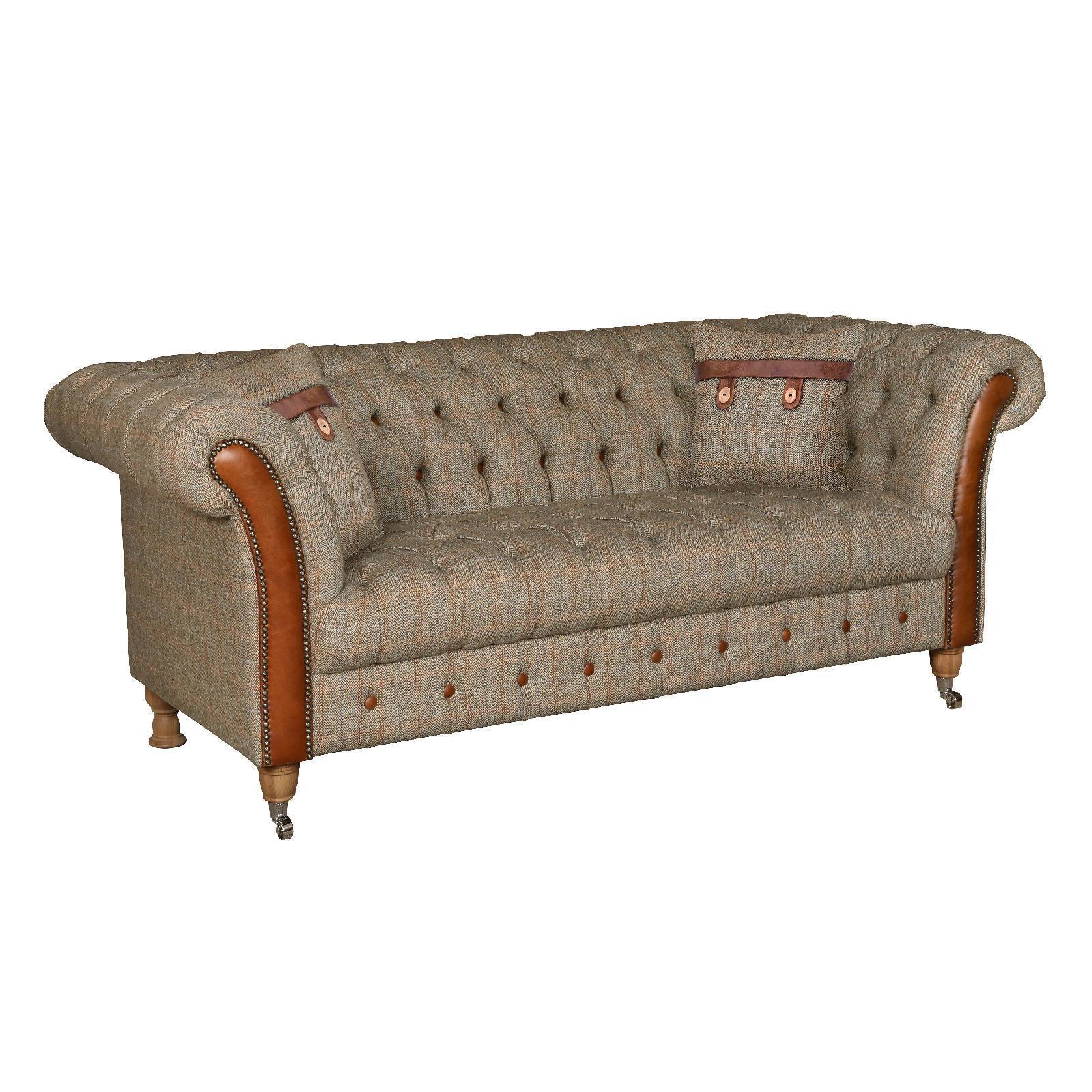 Chesterfield sofa with tweed fabric, tan leather trim, button tufting, and two matching cushions