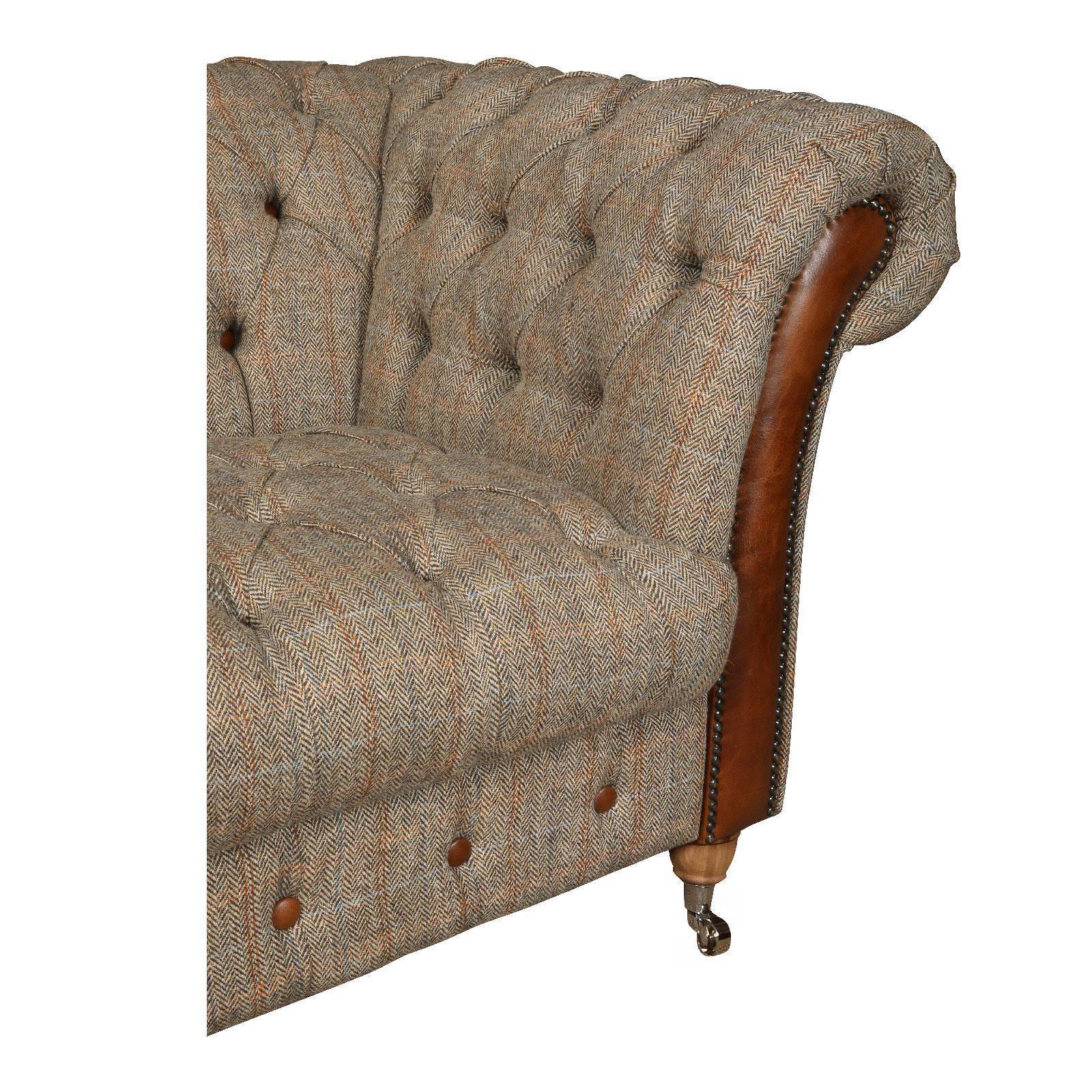 Herringbone tweed Chesterfield sofa corner with brown leather arm and button detail