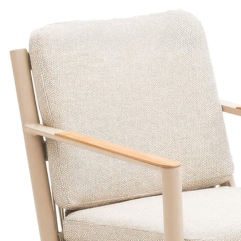 Beige fabric armchair with cushioned backrest and light wood armrest detail