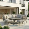 Grey outdoor corner sofa set with cushions and dining table on modern patio