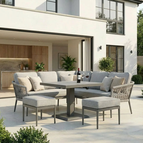 Grey outdoor corner sofa set with cushions, dining table and stools on modern patio