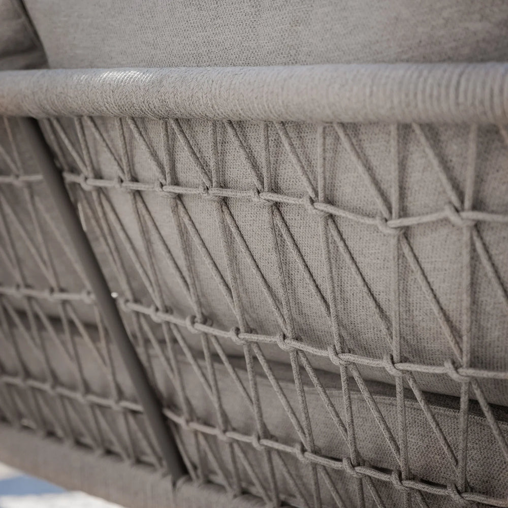 Close-up of woven rope backrest detail on grey outdoor sofa
