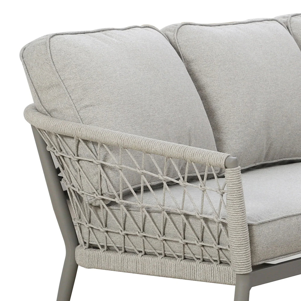 Light grey fabric sofa with rope woven armrest and plush cushions, corner view