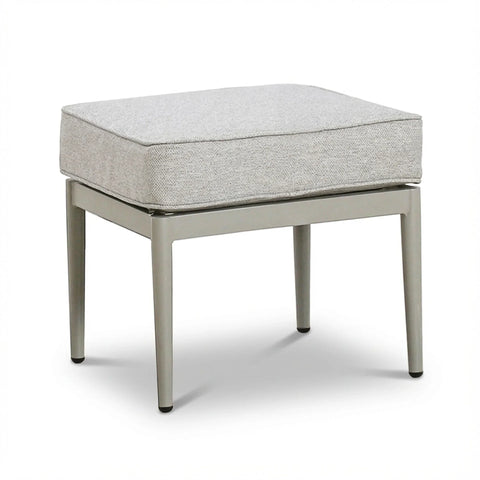 Modern ottoman with light grey cushion and metal legs on white background