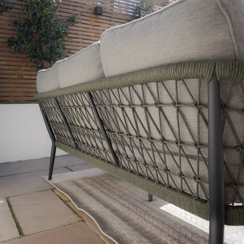 Back view of outdoor sofa with grey cushions and rope detail on black metal frame