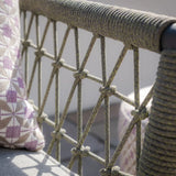Close-up of outdoor sofa rope detail with geometric cushion on patio