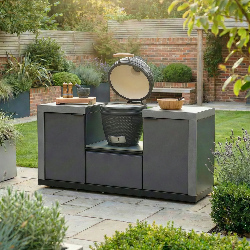 Modern outdoor kitchen with ceramic barbecue grill and countertop in garden setting