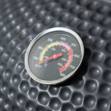 barbecue grill temperature gauge on textured black ceramic lid