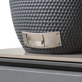 Detail of grey textured ceramic fire pit with stainless steel vent on stone base