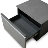 Grey bedside table with open drawer and matte finish, viewed from above