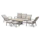 Grey garden furniture set with cushioned sofa, two armchairs, stools and wood-effect table