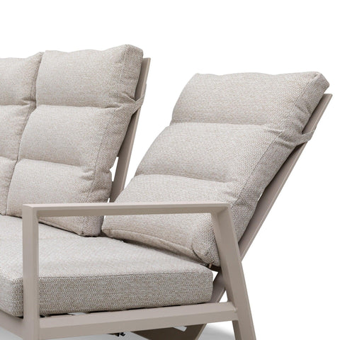 Beige fabric cushioned sofa with angled backrest and taupe metal armrest close-up