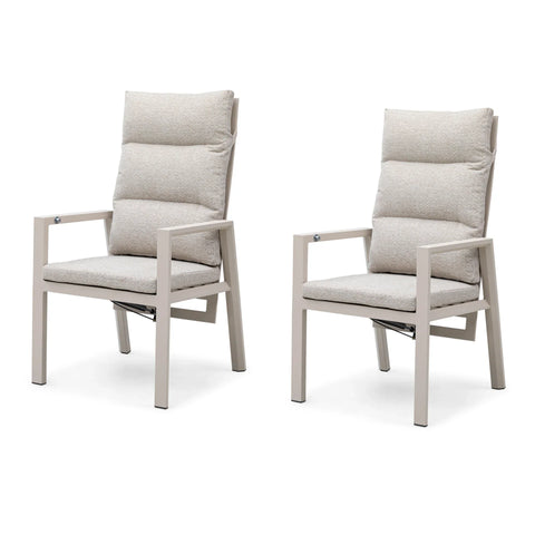 Pair of beige cushioned dining chairs with metal frames, side by side on white background