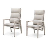 Pair of beige cushioned dining chairs with metal frames, side by side on white background