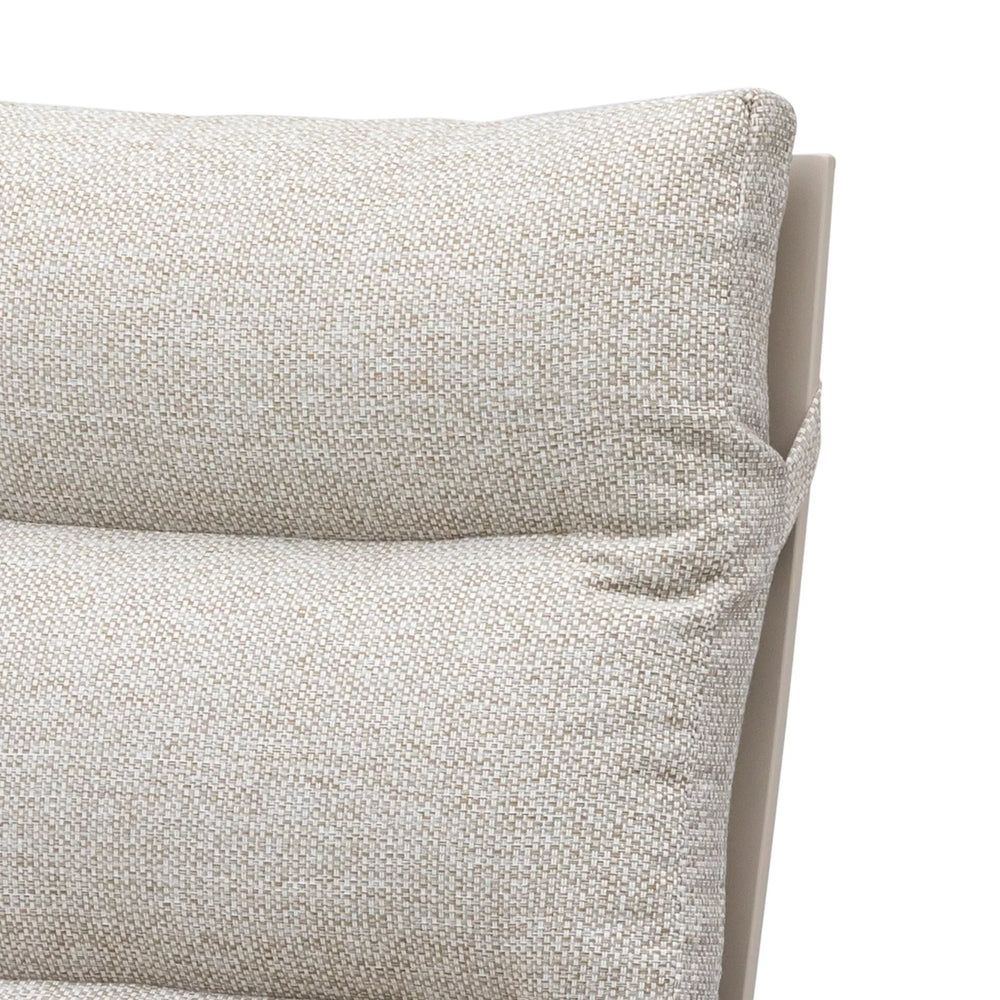 Close-up of beige fabric sofa cushion with textured detail and visible stitching