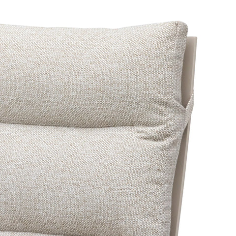 Close-up of beige fabric sofa cushion with textured detail and visible stitching