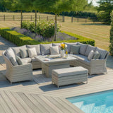 Grey rattan garden corner sofa set with cushions, glass-top table and bench by pool