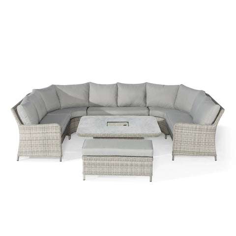 Grey rattan corner garden sofa set with cushions, square table and bench on white background