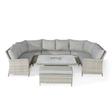 Grey rattan corner garden sofa set with cushions, square table and bench on white background