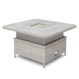 Square rattan outdoor dining table with grey stone-effect top and central cut-out feature