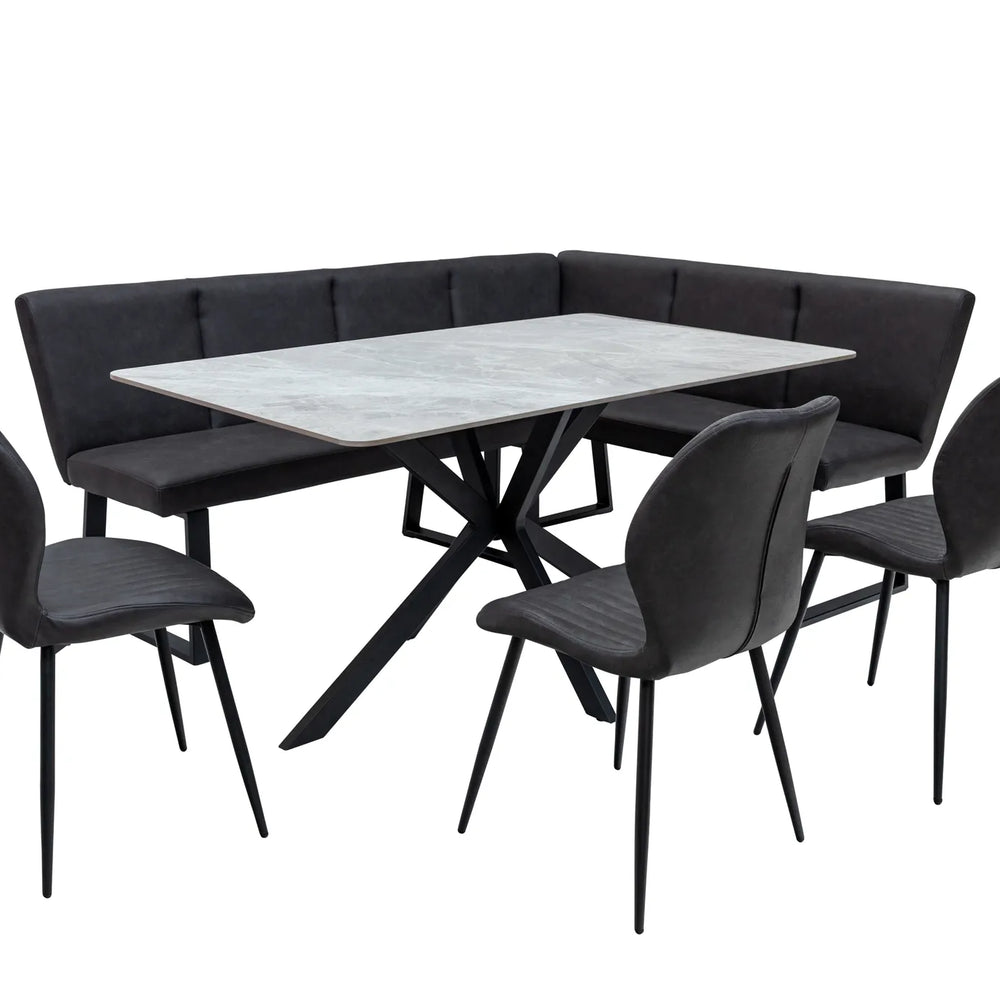 A 5-piece corner dining set featuring a rectangular white marble-patterned table with a black metal X-frame base, a black tufted corner banquette, and four matching black chairs with slim black legs, shown on a solid white background.