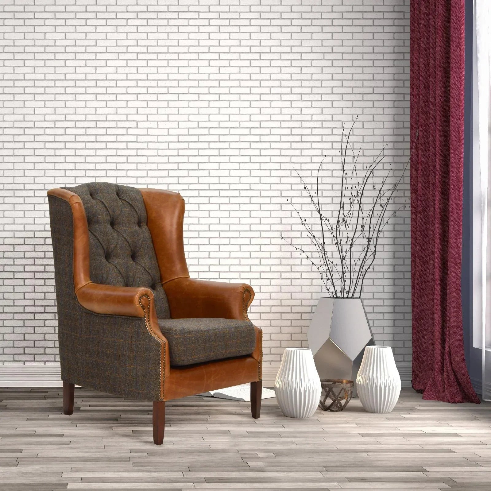 Brown leather and grey fabric armchair beside modern vases in living room with white brick wall
