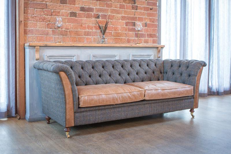 Grey and tan leather Chesterfield sofa with buttoned back in living room setting