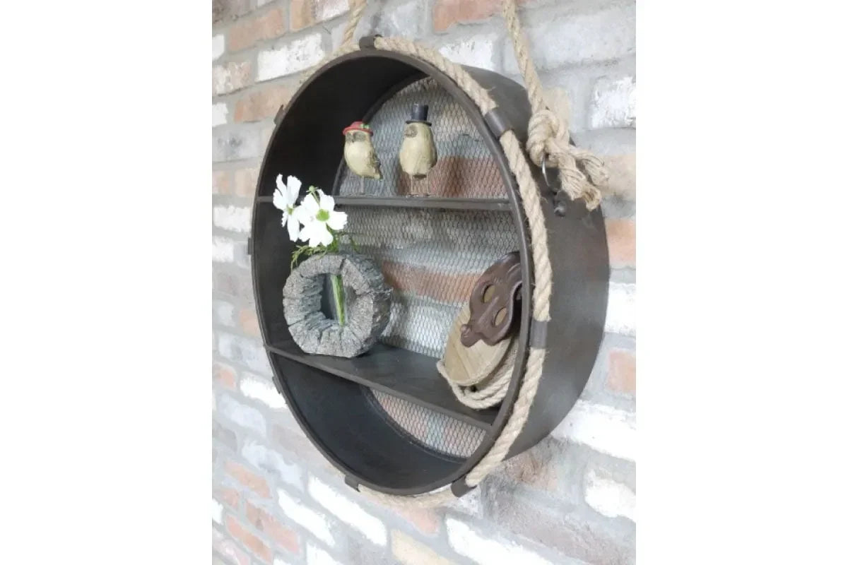 Round metal wall shelf with rope detail holding decorative ornaments and flowers