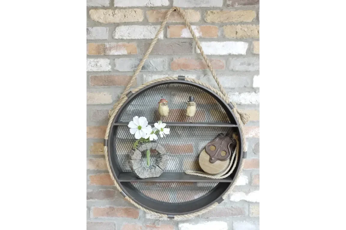 Round wall shelf with mesh backing, rope hanging, and decorative items on brick wall