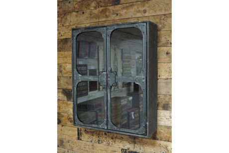 Wall-mounted black metal wall cabinet with two glass doors, viewed from a slight side angle against a wooden plank wall.