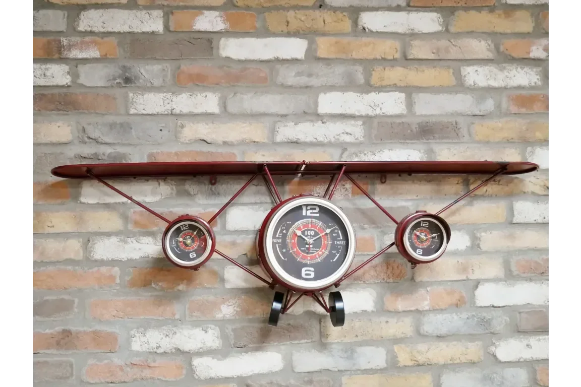 Vintage airplane wall clock with three dials mounted on exposed brick wall