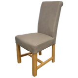 Beige upholstered dining chair with high back and light wood legs, side angle view