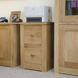 Oak filing cabinet with two drawers in office setting with printer on top