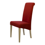Red fabric dining chair with light wood legs, side view