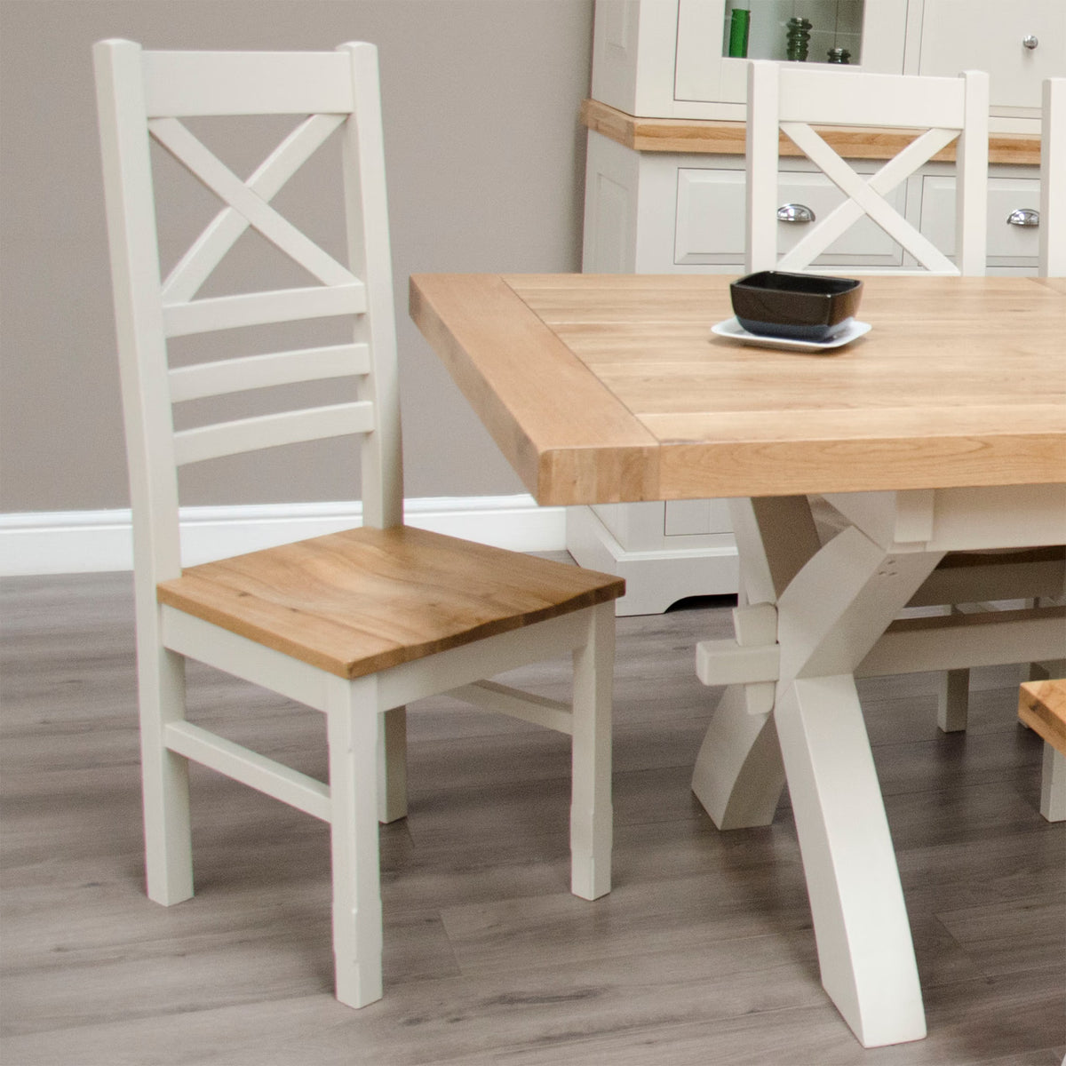 Oak and white dining table with matching cross-back chair in modern dining room