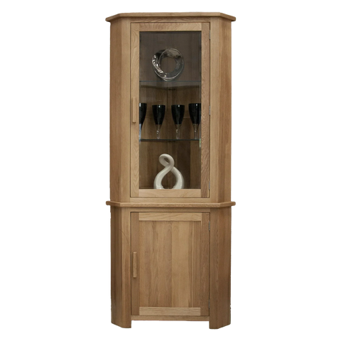 Oak corner display cabinet with glass door, wooden shelves, and decorative items inside