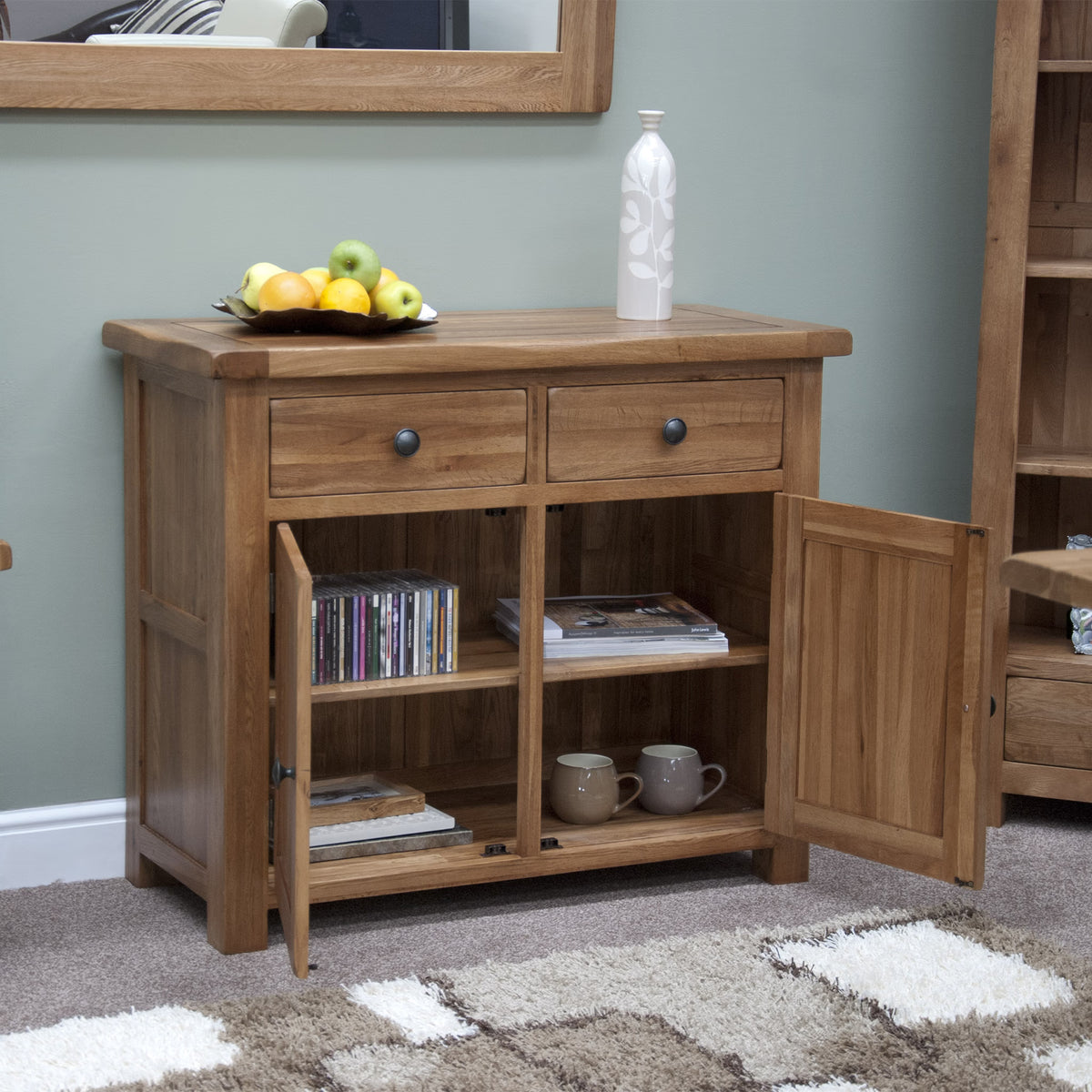 Oak sideboard with two drawers and open cabinet, displayed with fruit bowl and vase