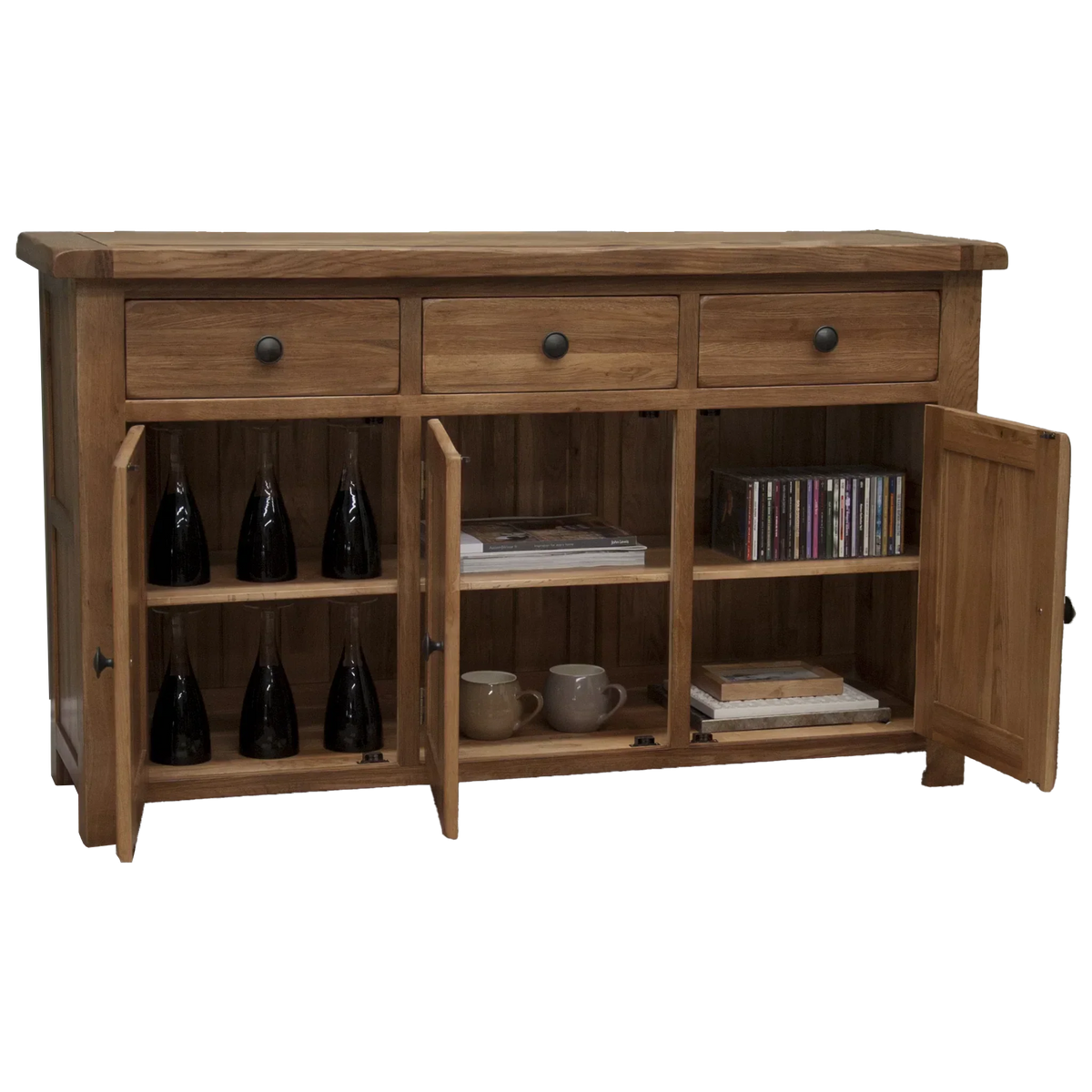 Oak sideboard with three drawers and open cupboards displaying bottles, cups, and CDs