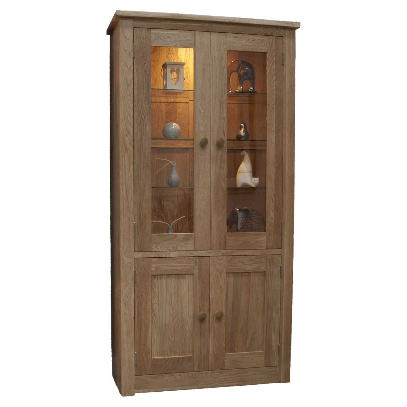 Oak display cabinet with glass doors, wooden shelves, lower storage, and decorative items