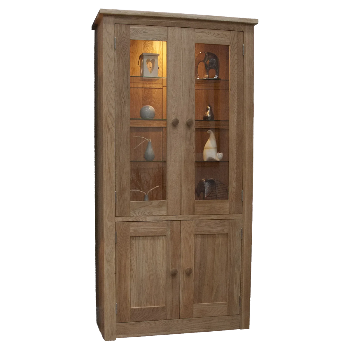 Oak display cabinet with glass doors, wooden shelves, lower storage, and decorative items