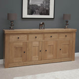 oak sideboard with four drawers and four doors in modern living room setting