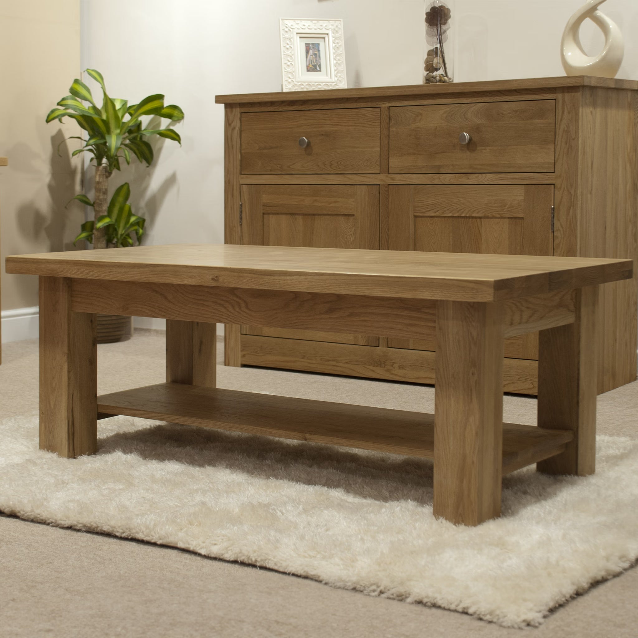 Oak coffee table with lower shelf on cream rug, matching sideboard in background