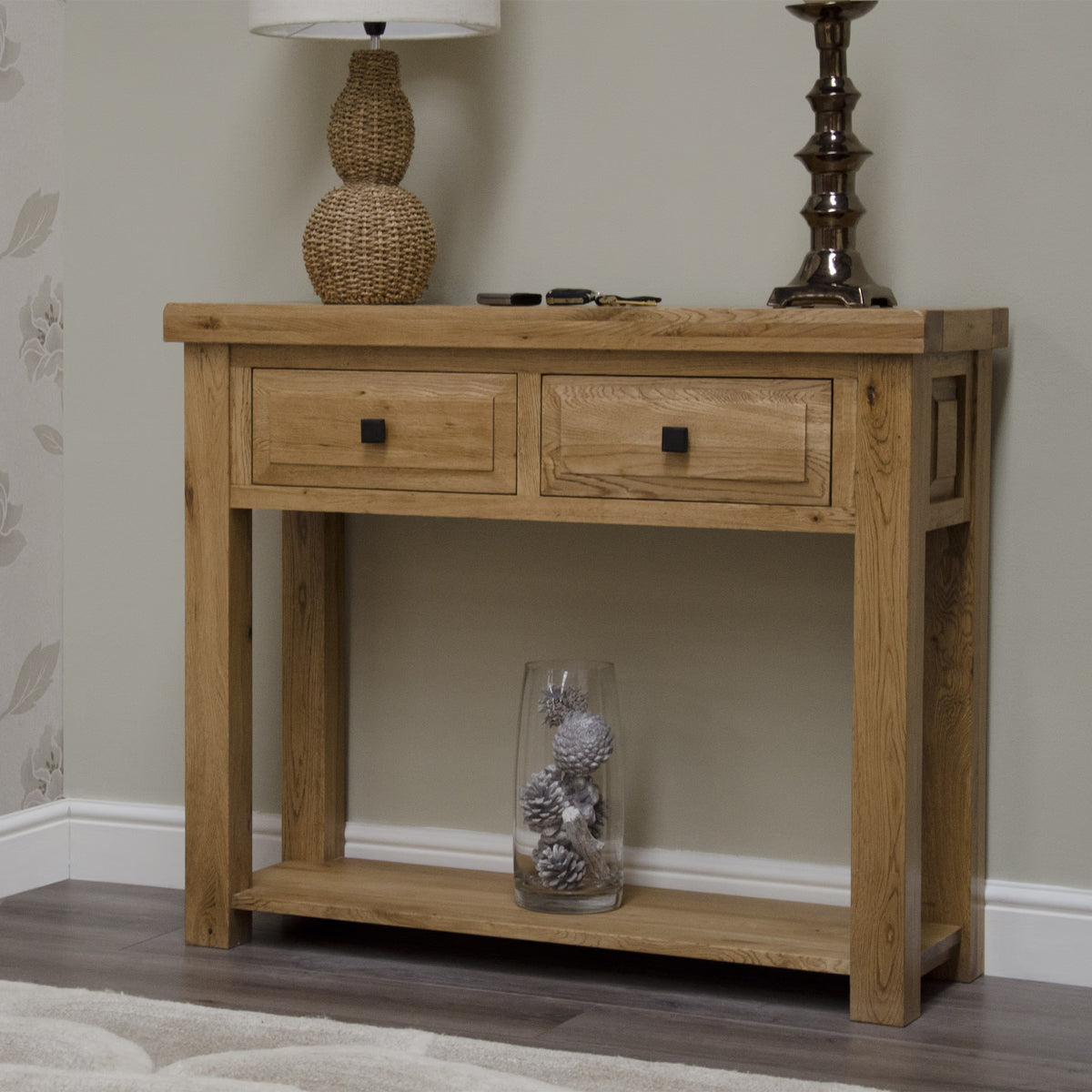 Oak console table with two drawers and lower shelf, styled with lamps and decor in hallway