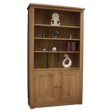 Oak bookcase with three shelves, lower cabinet doors, and decorative items displayed